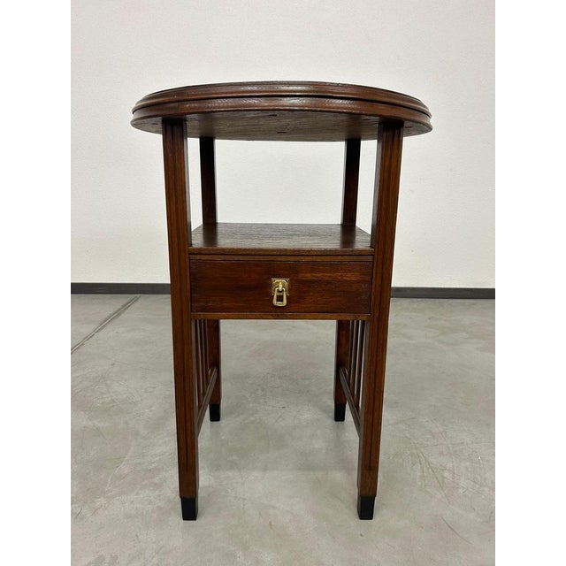 Art deco round table with brass top.