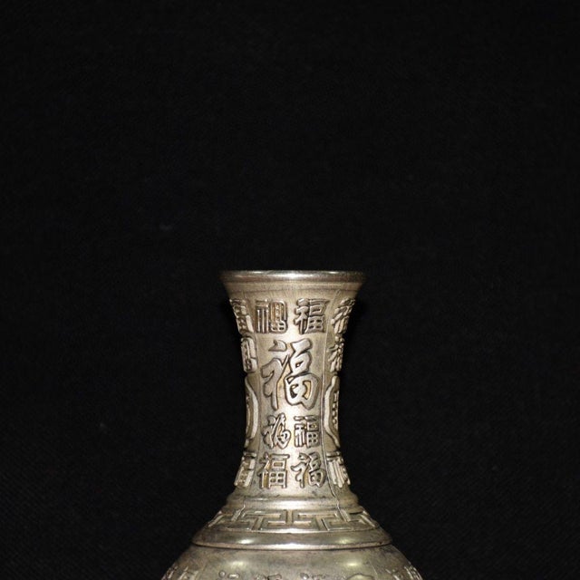 Add a touch of auspicious elegance to your home with this vintage silver-tone copper vase. This beautifully crafted vessel...