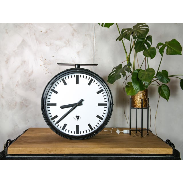 Step into history with this rare vintage double-faced railway clock by telenorma, a genuine timepiece from the 1950s...