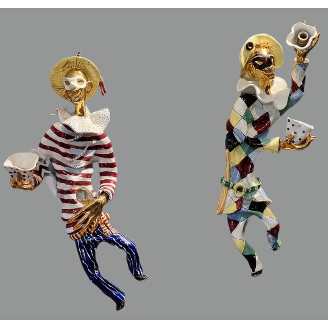 A striking pair of glazed and gilded ceramic wall sconces depicting two characters from Venetian tradition and the...