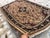 This exquisite hand-knotted wool area rug features a classic Caucasian design. The center field displays a prominent, dark...