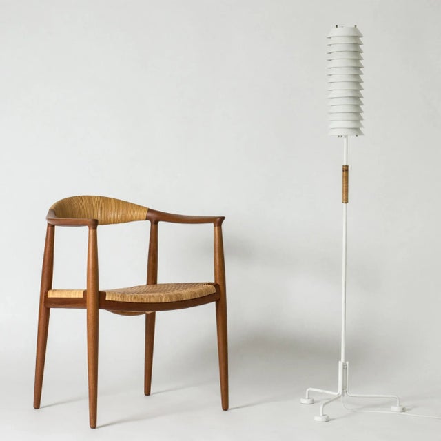 Striking “Maija Mehiläinen” (“Maija the Bee”) floor lamp by Ilmari Tapiovaara. Stacked white lacquered lamellas let out a...