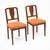 Pair of dining chairs from France made of solid wood construction, primarily walnut. The pair have a beautiful cut out...