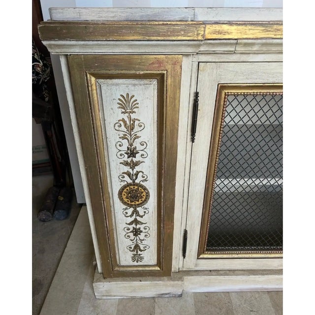 Gorgeous neoclassical style gilt and paint decorated cabinet, previously sold by the esteemed Newel in NYC