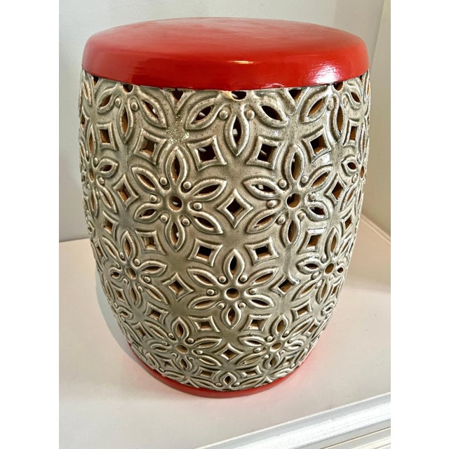 Lovely midcentury modern stool or side table in cream and tangerine. Geometric cutouts make this piece light and breezy....