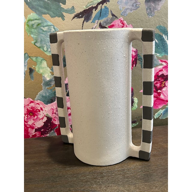 A touch of modern geometry. This ceramic white vase with two striped handles is great alone or with fresh or dried...