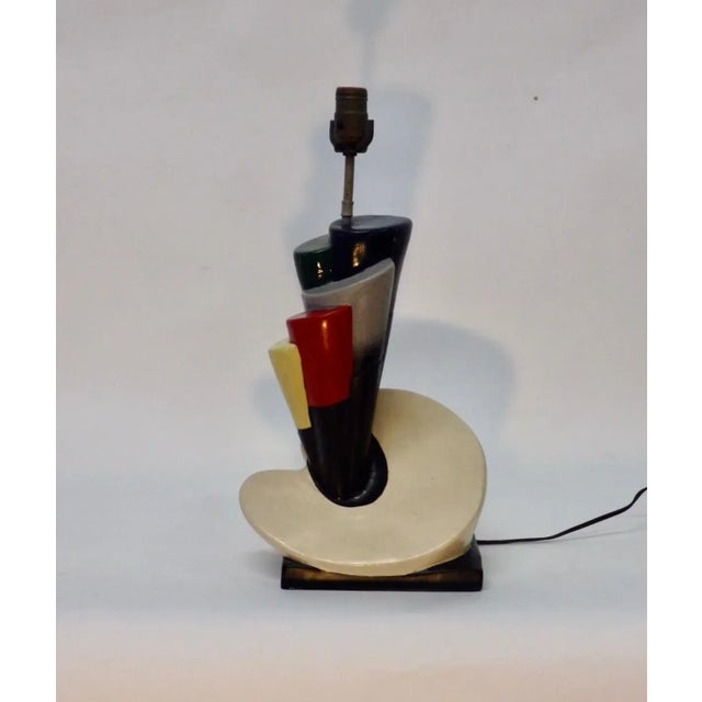 Neat Kitsch plaster table lamp. Artist palette with multi-color paint brush protruding. Shade not included.