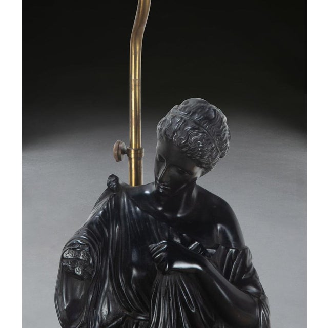 A large pair of neo-classical lamps, with composition hopper style figures of diane de gabies, raised on scagliola bases....