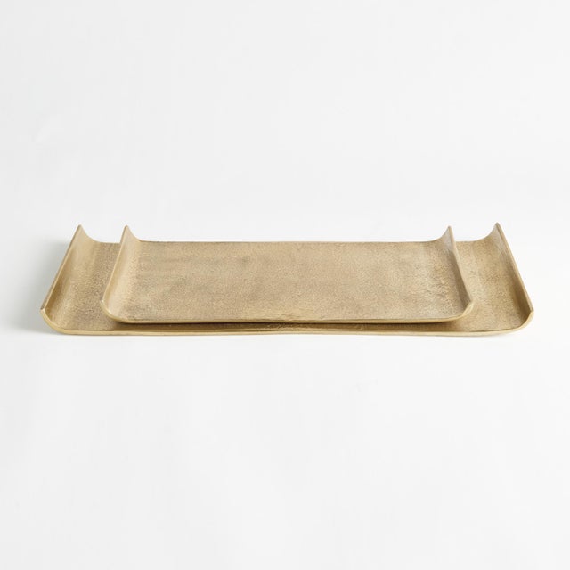 This pair of elongated cast aluminum trays is a beautiful way to display a styled vignette with books and vase or...