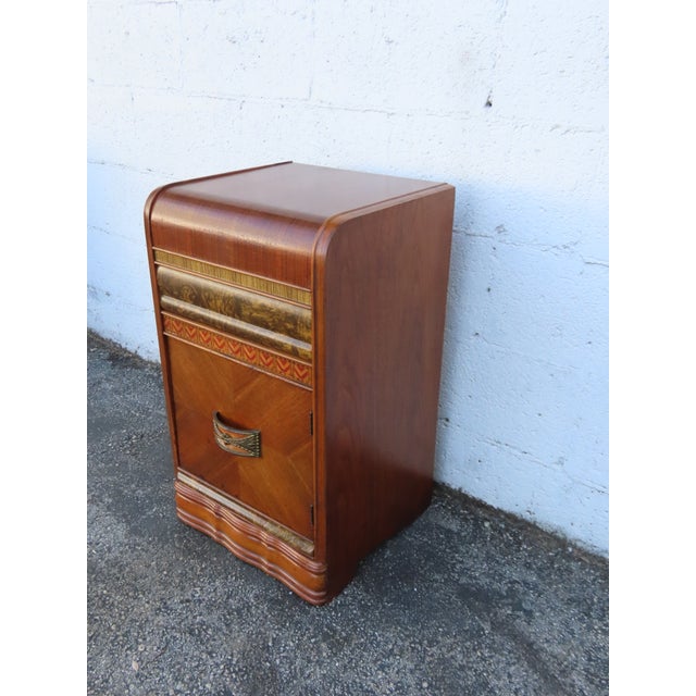 This delightful Nightstand Side End Table is made of wood, solid wood, walnut, mixed wood, veneer, Bakelite, and metal....