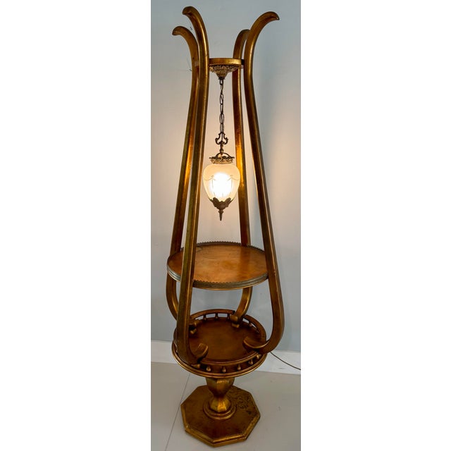 A central hanging fixture with an ornate frosted glass shade, typical of mid-20th-century Hollywood Regency and...