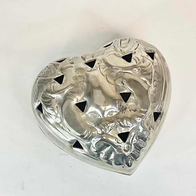A lovely heart shaped silver plate box. Its pierced lid is to accommodate burning incense or filling with potpourri....