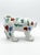 Description: Charming, hand-painted ceramic dog figurine featuring a whimsical folk art style. Glazed in a glossy white...