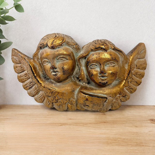 Vintage-style double cherub angel wall plaque features a classic Renaissance-inspired design with two angelic faces and...