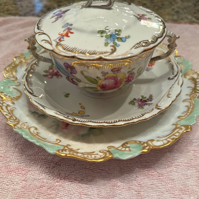 An exquisite late 19th to early 20th-century German fine porcelain bouillon/cream soup set decorated by the master...