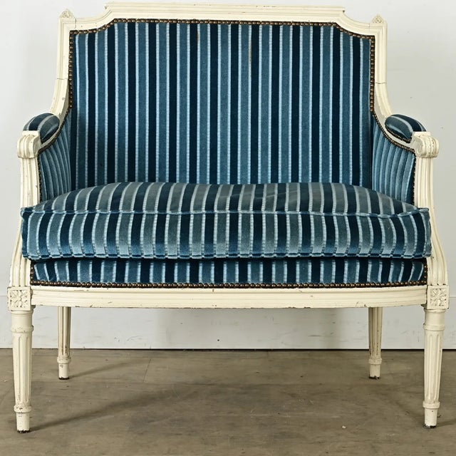 A French Louis XVI marquise bergère, commonly known as a chair and a half, from the 19th century. This example features...