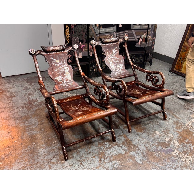 Design Plus Gallery presents a Pair of Chinoiserie Mother-of-Pearl Moon Gazing Recliner Chairs. The pair has ornate...