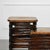 Art Deco two-tier stacked rattan end tables with cut-out sides and mahogany wood top. Professionally restored with a...