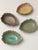 A set of four leaf-shaped ceramic small dishes; each is modeled in the form of a leaf with a natural, serrated edge, and...