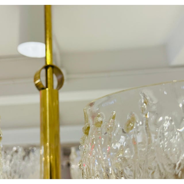 A rare 1970s Swedish six light polished brass pendant with floral molded glass shades. Rewired.
