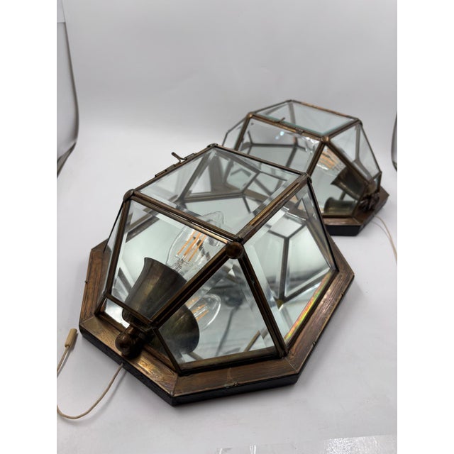 Pair of wall lights made of metal/brass-look glass in an angular, geometric design. Both lights are equipped with a cable...