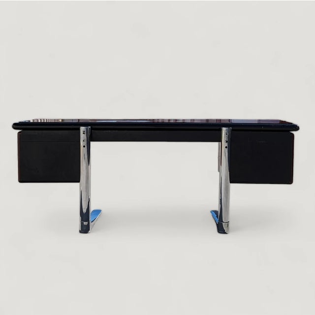 Bring timeless design into your home with this Mid-Century Modern executive desk in burl, lacquer, and chrome. Design...