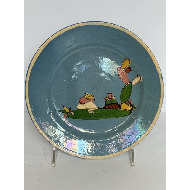 Antique blue tlaquepaque with classic landscape pattern and simple white band. Embossed on the back MEXICO.