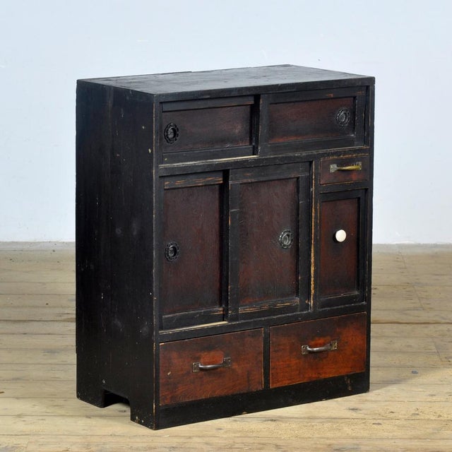 This Japanese cabinet with drawers and sliding doors is an attractive eye-catcher for any interior. Crafted from solid...