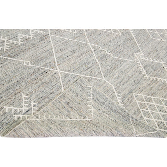 Beautiful kilim handmade wool rug with a gray field. This custom modern flatweave rug part of our Nantucket collection has...