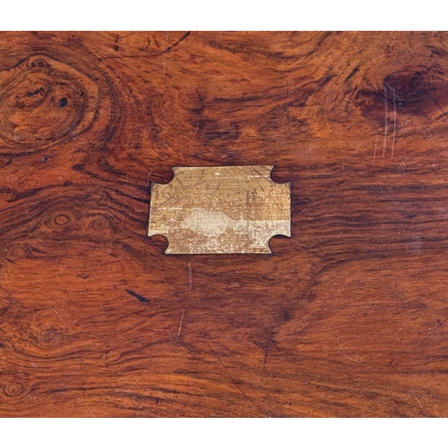 Rectangular walnut veneer case with brass inlaid name plate and escutcheon to the front. Hinged lid with simple interior.