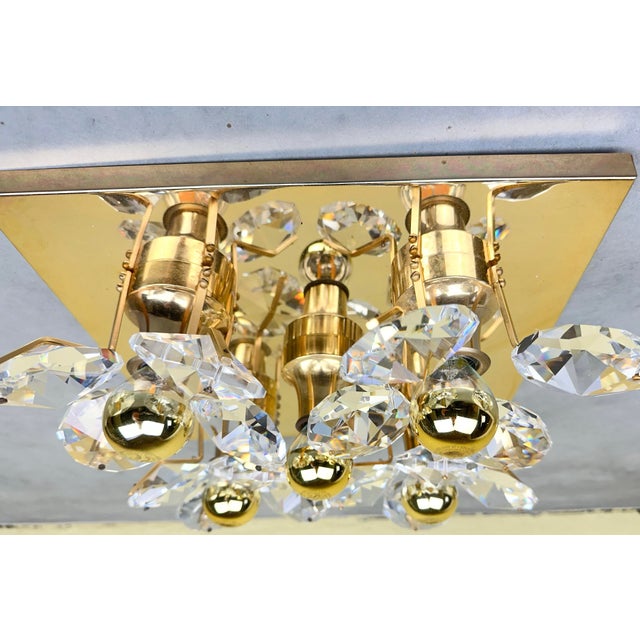 A beautiful Hollywood Regency wall lamp. Made by the German company Palwa in the 1960s and 1970s. It has a square brass...