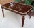 Glamorous and sophisticated deep burgundy lacquered coffee table with gold trim. This high style coffee table is...