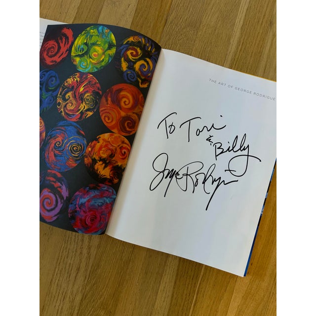 The ultimate coffee table book… this 1st edition copy of “The Art of George Rodrigue” is inscribed by the artist on the...