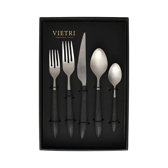 The contemporary matte handle found on the Ares Argento Black Five-Piece Place Setting provides perfect balance and weight...