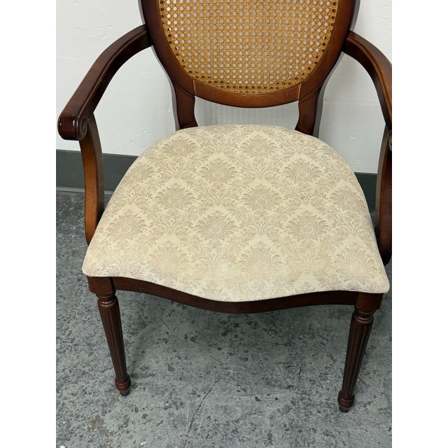 Design Plus Gallery presents a Traditional Oval Cane-Back Armchair from The Bombay Company. The chair is constructed with...