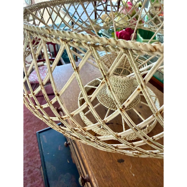 Charming French Wire Basket Large footed woven wire basket with handle that folds up/down. Soft creamy white patina....