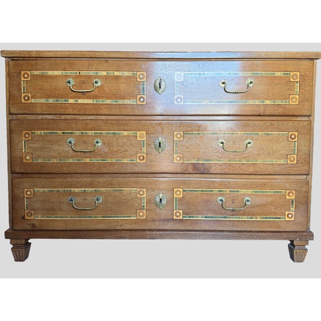 Elegant antique chest of drawers crafted in walnut with fine marquetry and geometric inlay details in the Empire /...