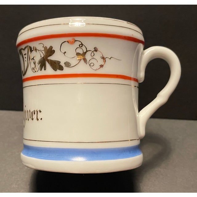 Antique "Love the Giver" coffee cup or cann. Porcelain with gilt decoration with maroon and blue stripes. This is perfect...