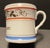 Antique "Love the Giver" coffee cup or cann. Porcelain with gilt decoration with maroon and blue stripes. This is perfect...