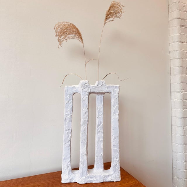 Tall vase with two mouths, made of hand formed Italian ceramic with a matte white finish.