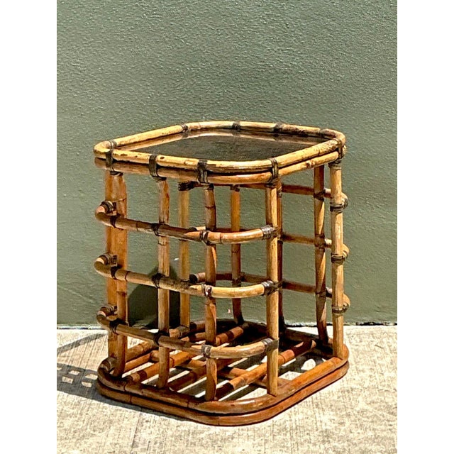 Exuding mid-century organic charm and breezy coastal style, this vintage side table showcases expertly crafted rattan...