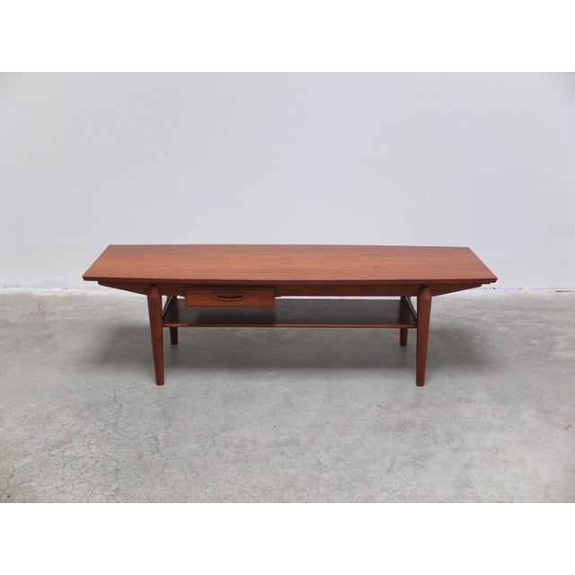 Beautiful coffee table in teak wood produced by Ouwenbroek Meubel Fabriek (O.M.F.) in The Netherlands around 1960. This...