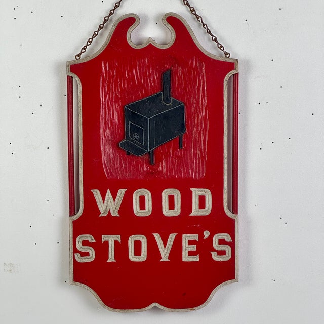 A beautiful vintage wooden trade sign advertising wood stove's. It's all done in carved wood with classical shield/tavern-...