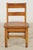 Vintage Shaker style children’s chair in medium toned wood. Straight legs, slats, and stretchers are softened by a slight...
