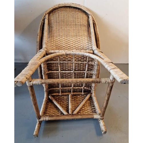 A vintage pair of Country style Burmese hand woven rattan lounge chairs from the mid 20th century, with looping, out...
