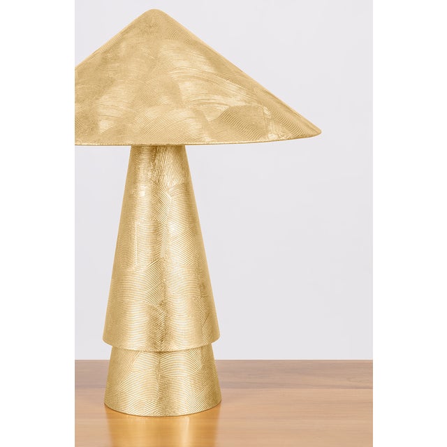 Inspired by antiquities, the Foxton table lamp cuts a bold figure with artistic geometry and textural finishes. The...
