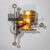 Large sculptural wall light in the Brutalist style featuring circular elements and amber-colored glass inserts in varying...