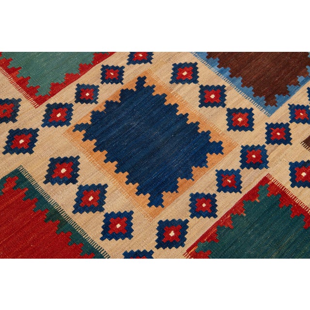 Beautiful Modern Kilim hand-knotted wool rug with multicolor accents in an all-over geometric design. This rug measures...