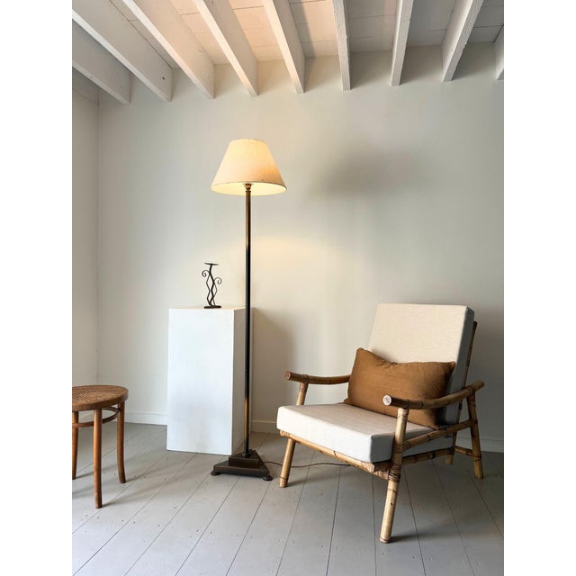 A vintage art deco style lamp with a stepped triangular base and minimal stem. This 20th century floor standing light is...