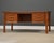 A mid century modern teak double bank desk with sculpted pulls, lipped top and a finished back. Made in Denmark....